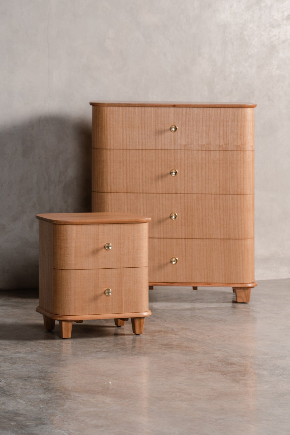 wooden bedside table with drawers, beside wooden chest of drawers