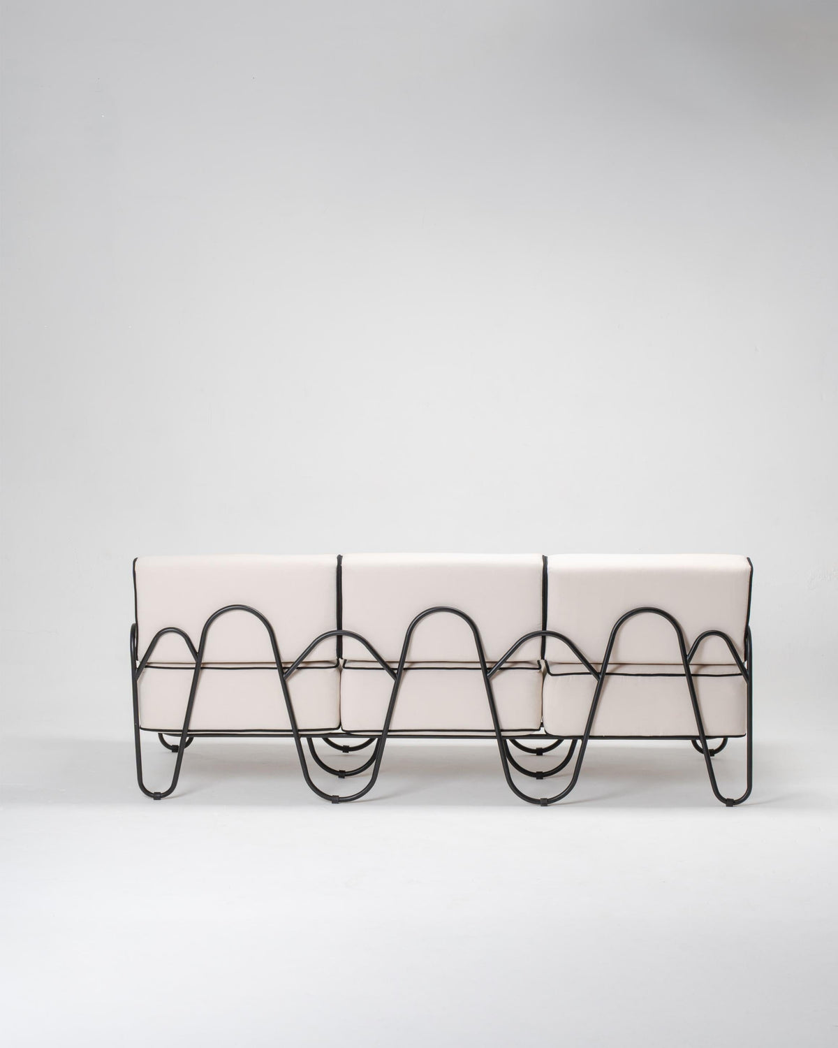 Modern outdoor couch with wavy metal legs