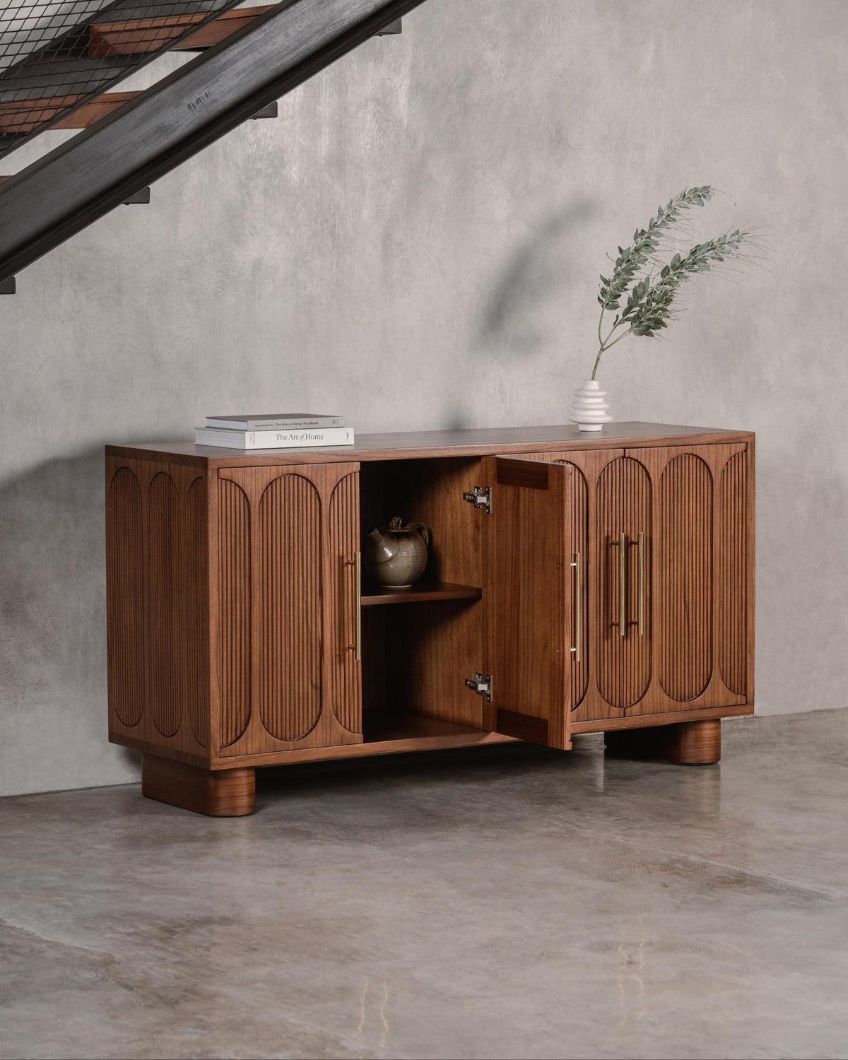 dark wooden sideboard with open door