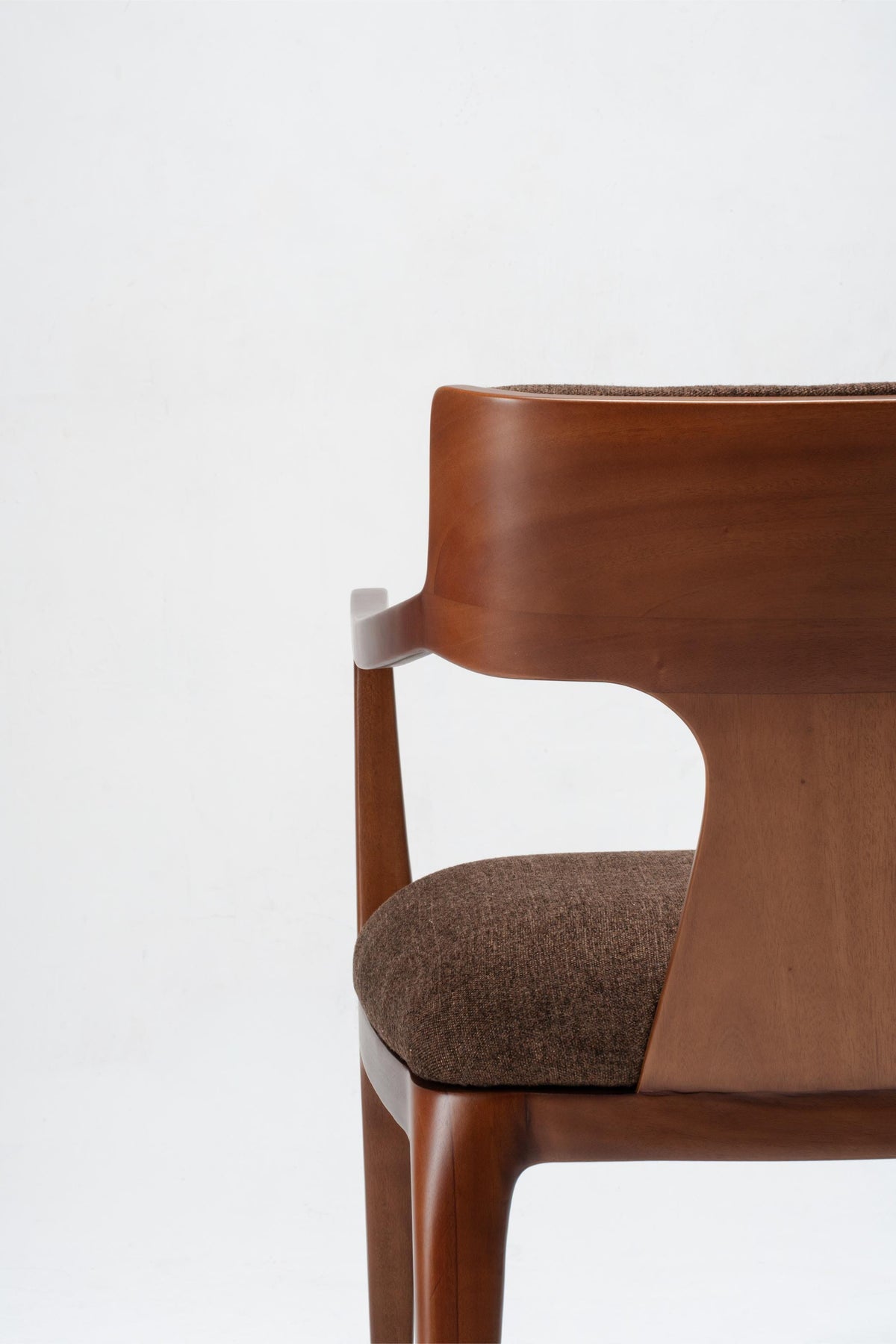 Brown wooden chair with a textured fabric