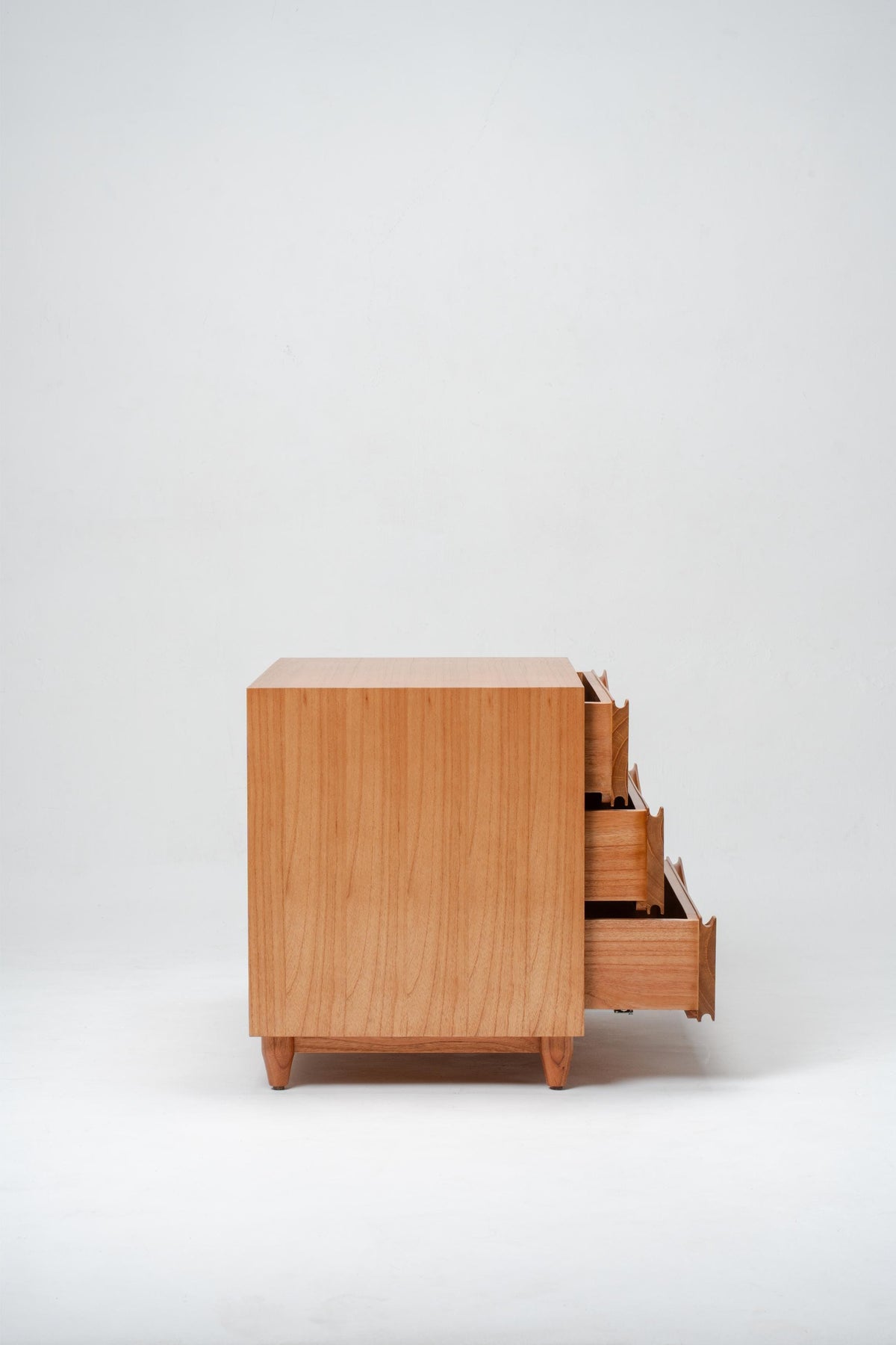 Wooden bedside drawer with open drawer on a white background