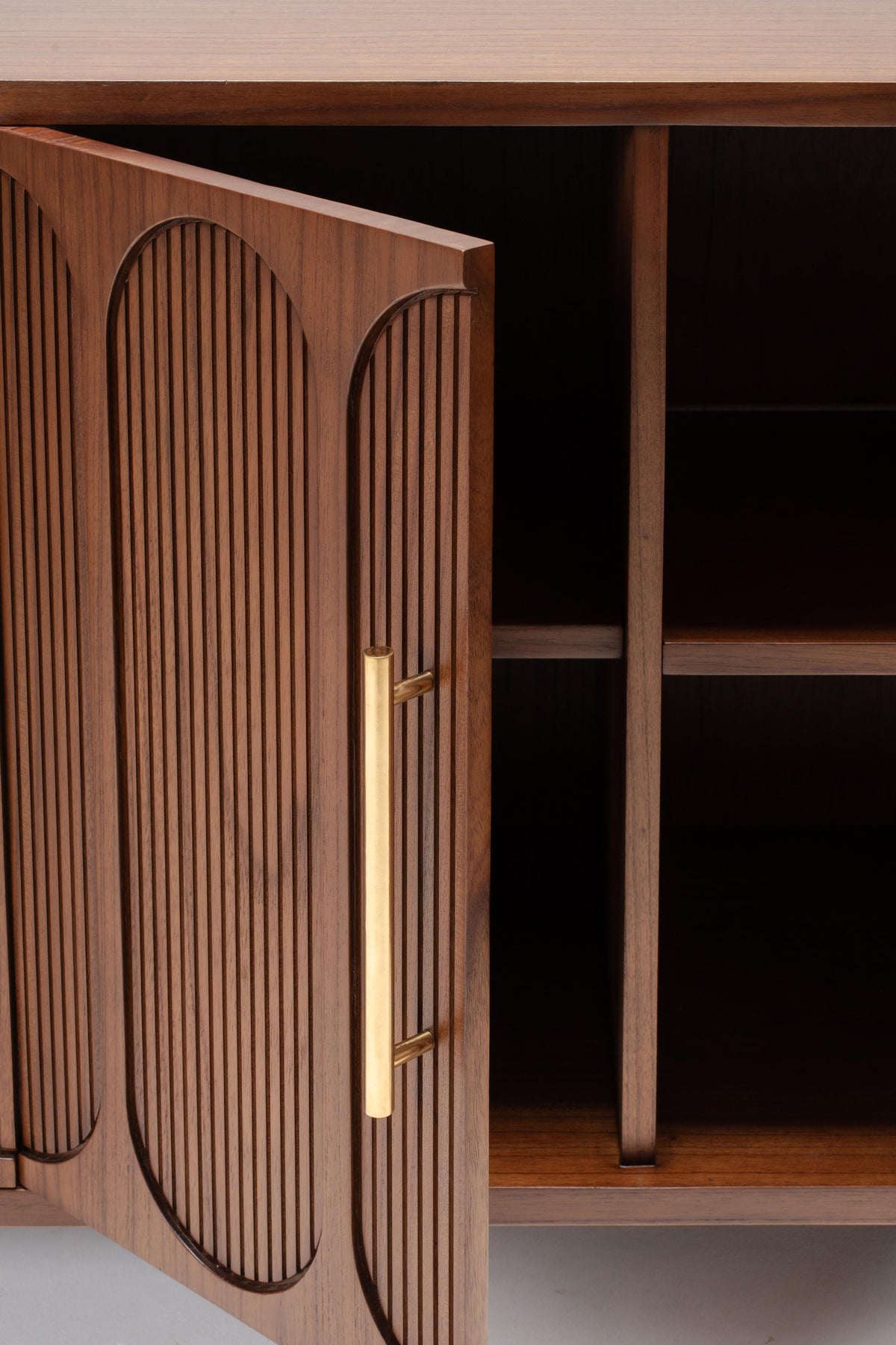 Wooden cabinet with large brass handles and shelves