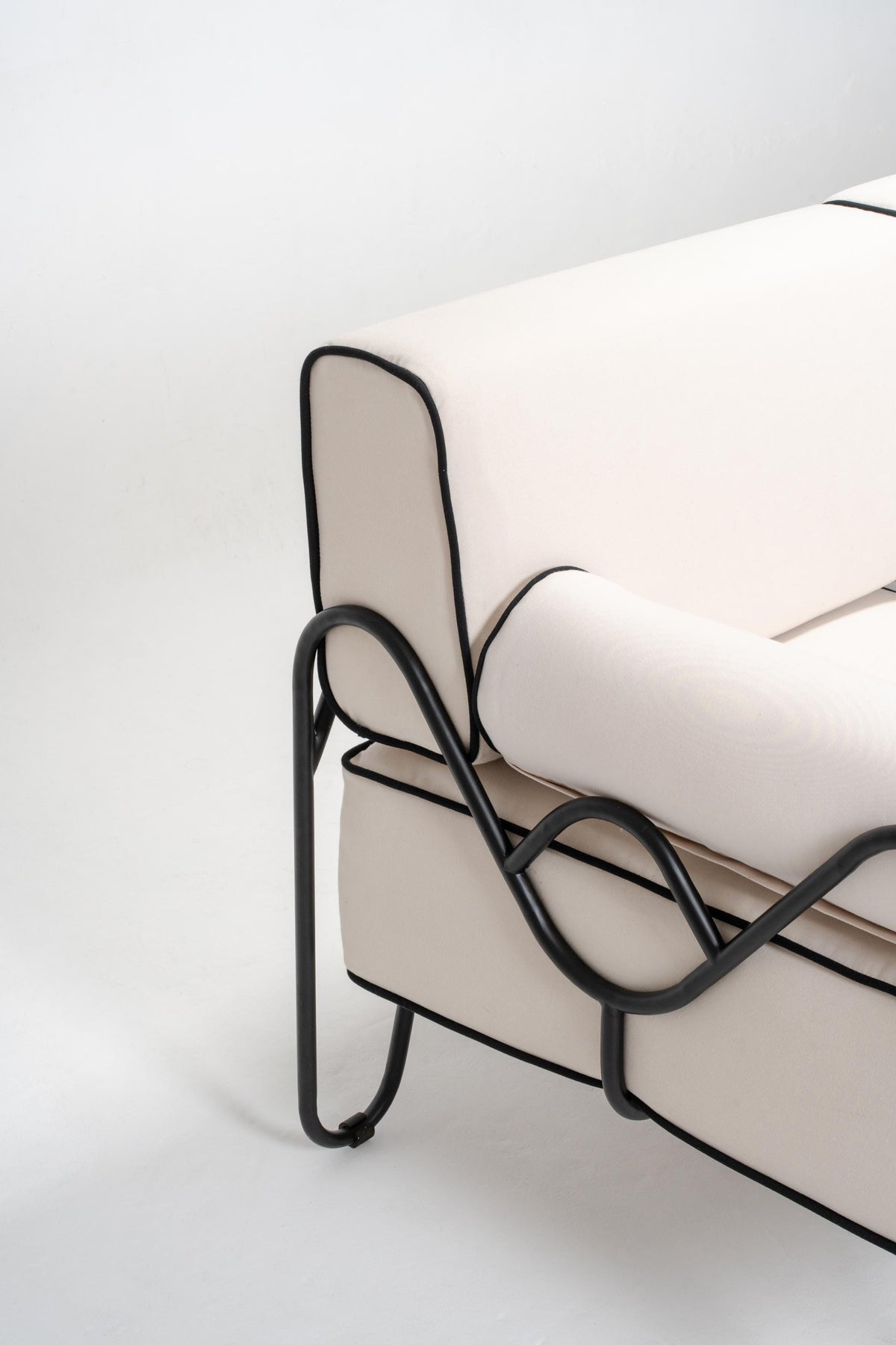 close up outdoor couch, white cushion, black powder coated stainless steel