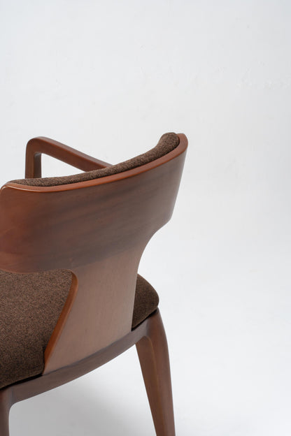 Brown dining chair with wooden frame on a white background