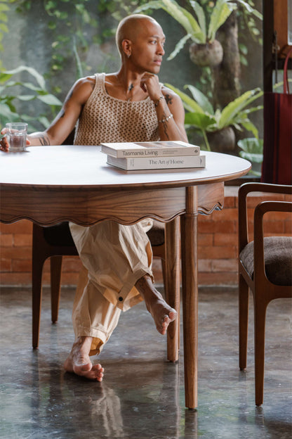 person sitting on wood dining chair