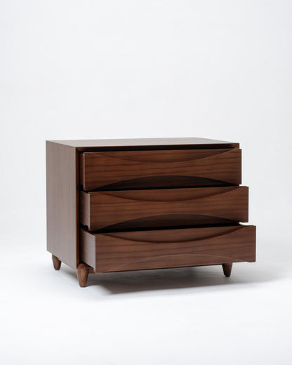 Wooden dresser with three drawers on a white background