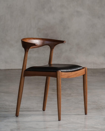 dark wooden chair with black leather seat